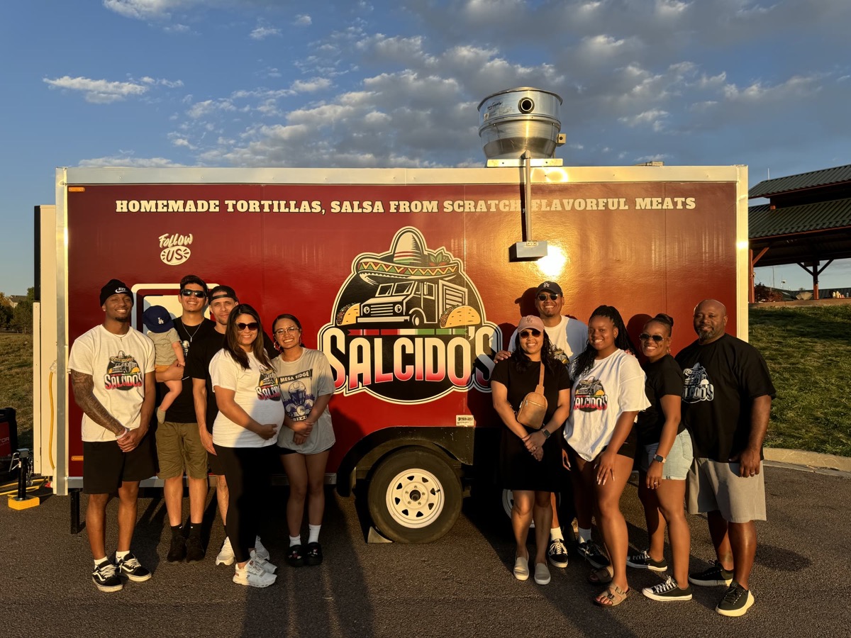 The Salcido's family and community standing together in front of the food truck