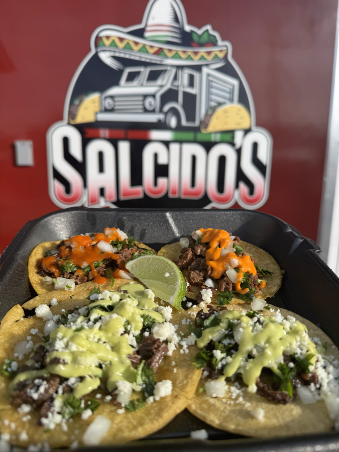 Salcido's tacos served in front of the food truck badge